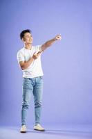 image of asian boy posing on purple background photo