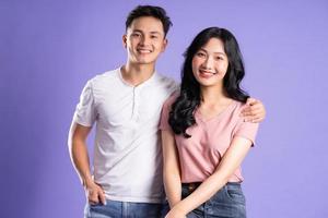 image of asian couple posing on purple background photo