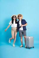 Asian couple traveling image  isolated on blue background photo