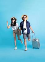 Asian couple traveling image  isolated on blue background photo