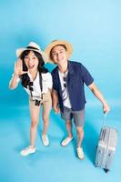 Asian couple traveling image  isolated on blue background photo