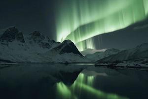 Aurora borealis on the Norway. Green northern lights above mountains. Night sky with polar lights. Night winter landscape with aurora photo