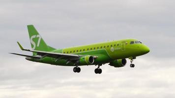 NOVOSIBIRSK, RUSSIAN FEDERATION JULY 15, 2022 - Side view, Embraer E170 of S7 Airlines approaching before landing. Airplane flies. Tourism and travel concept video