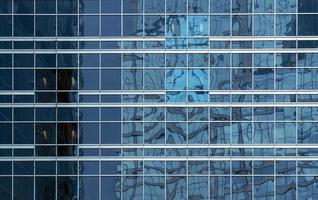 office building windows texture of blue glass for business background, business center generic facade, front view photo