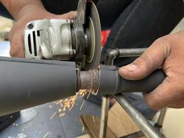 Worker cutting metal by industry tool cutting steel.  industrial manufacturing theme photo