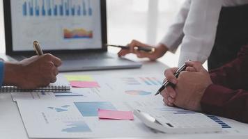 Financial analysts analyze business financial reports on a digital tablet planning investment project during a discussion at a meeting of corporate showing the results of their successful teamwork. video