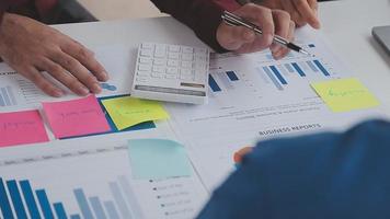 Financial analysts analyze business financial reports on a digital tablet planning investment project during a discussion at a meeting of corporate showing the results of their successful teamwork. video