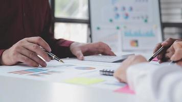 Financial analysts analyze business financial reports on a digital tablet planning investment project during a discussion at a meeting of corporate showing the results of their successful teamwork. video