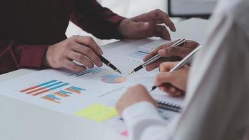 Financial analysts analyze business financial reports on a digital tablet planning investment project during a discussion at a meeting of corporate showing the results of their successful teamwork. video
