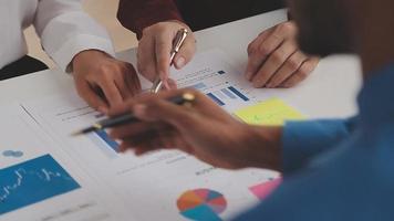 Financial analysts analyze business financial reports on a digital tablet planning investment project during a discussion at a meeting of corporate showing the results of their successful teamwork. video
