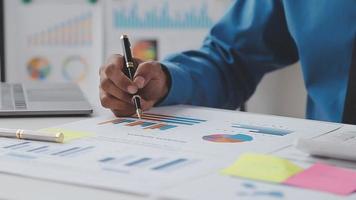 Financial analysts analyze business financial reports on a digital tablet planning investment project during a discussion at a meeting of corporate showing the results of their successful teamwork. video