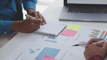 Financial analysts analyze business financial reports on a digital tablet planning investment project during a discussion at a meeting of corporate showing the results of their successful teamwork. video