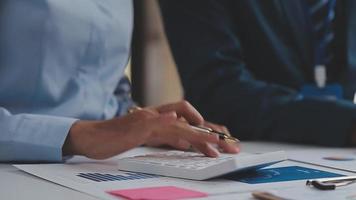 Financial analysts analyze business financial reports on a digital tablet planning investment project during a discussion at a meeting of corporate showing the results of their successful teamwork. video