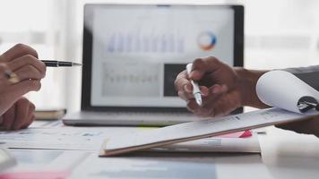 Financial analysts analyze business financial reports on a digital tablet planning investment project during a discussion at a meeting of corporate showing the results of their successful teamwork. video