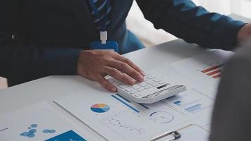 Financial analysts analyze business financial reports on a digital tablet planning investment project during a discussion at a meeting of corporate showing the results of their successful teamwork. video