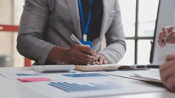 Financial analysts analyze business financial reports on a digital tablet planning investment project during a discussion at a meeting of corporate showing the results of their successful teamwork. video