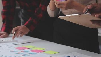 Financial analysts analyze business financial reports on a digital tablet planning investment project during a discussion at a meeting of corporate showing the results of their successful teamwork. video