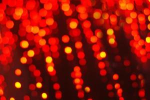 Abstract festive background of red blurry garland lights photo