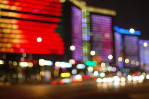 Colorful bright city lights at night, urban bokeh background photo