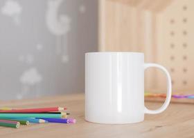 White kids mug mock up. Blank template for your design, advertising, logo. Close-up view. Copy space. Cup standing in children room. Playful cup mockup. 3D rendering. photo