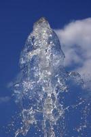 spurt of water over cloudy sky photo