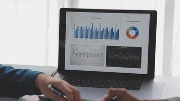 Financial analysts analyze business financial reports on a digital tablet planning investment project during a discussion at a meeting of corporate showing the results of their successful teamwork. video