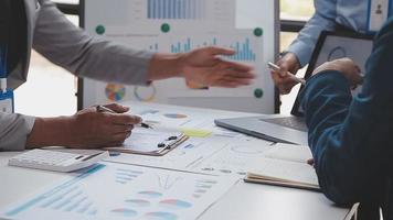 Financial analysts analyze business financial reports on a digital tablet planning investment project during a discussion at a meeting of corporate showing the results of their successful teamwork. video