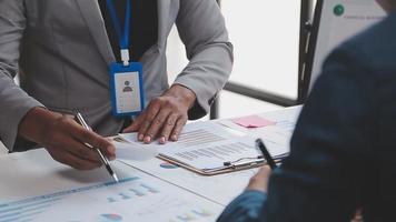 Financial analysts analyze business financial reports on a digital tablet planning investment project during a discussion at a meeting of corporate showing the results of their successful teamwork. video