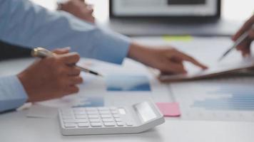 Financial analysts analyze business financial reports on a digital tablet planning investment project during a discussion at a meeting of corporate showing the results of their successful teamwork. video