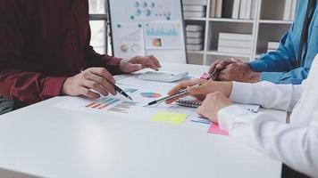 Financial analysts analyze business financial reports on a digital tablet planning investment project during a discussion at a meeting of corporate showing the results of their successful teamwork. video