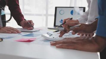 Financial analysts analyze business financial reports on a digital tablet planning investment project during a discussion at a meeting of corporate showing the results of their successful teamwork. video