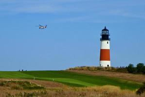 Nantucket lighthouse with helicopter flying by photo