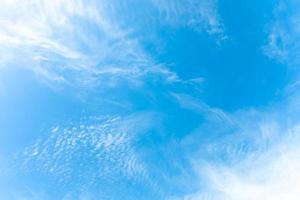 Summer bright blue sky with sunlight and natural white clouds. Copy space in the middle. photo