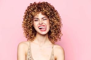 woman A grimace licks the curly hair model's lip bright makeup photo