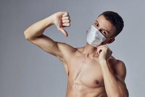 sport man showing thumb down medical mask health workout photo