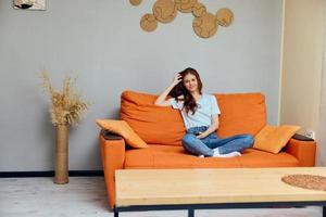 portrait of a woman with a phone in his hands on the couch technologies photo