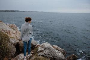 woman sweaters cloudy sea admiring nature unaltered photo