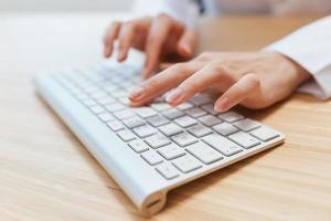 Closeup shot hands of businesswoman journalist office worker freelancer typing report doing documents on keyboard. Online communication, Remote job or Education. Copy space, wide angle photo