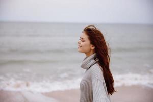 cheerful woman cloudy weather by the sea travel fresh air unaltered photo