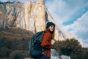 Cheerful woman tourists mountains nature clouds travel photo