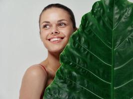 cheerful woman palm leaf exotic studio closeup photo