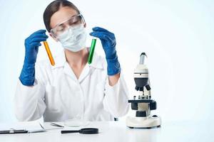 woman chemist analyzes laboratory research microscope photo