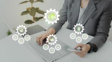 ESG environment social governance investment business concept. Women use a computer to analyze ESG, surrounded by ESG icons .close to the computer screen in business investment strategy concept. photo
