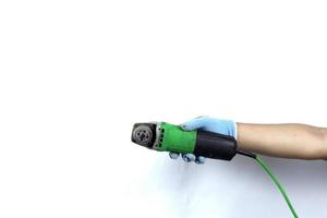 Gloved hand holding  angle grinder machine isolated on white background photo