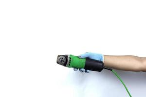 Gloved hand holding  angle grinder machine isolated on white background photo