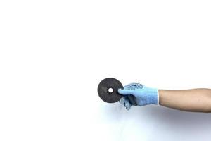 Gloved hand holding Angle grinder disc isolated on white background photo