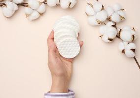 Woman's hand holding cotton pads photo
