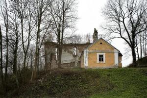 old historic house with wall ruins on gray november day in Podlasie, Poland photo