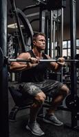 Aphoto of the athlete working out on a bodybuilding machine, photo