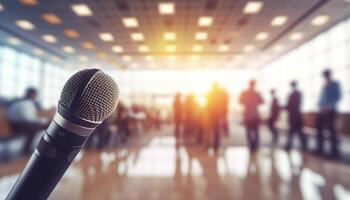Microphone over the Abstract blurred photo of conference hall. Business meeting and education concept.